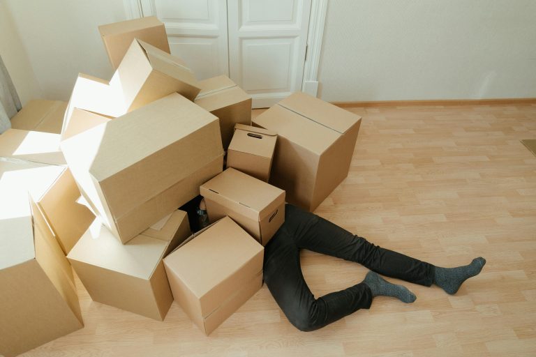 Man buried in moving boxes