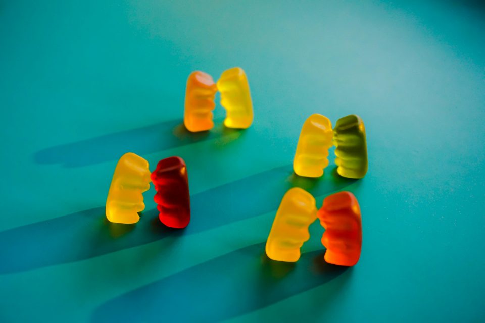 four pairs of gummy bears set up face to face.